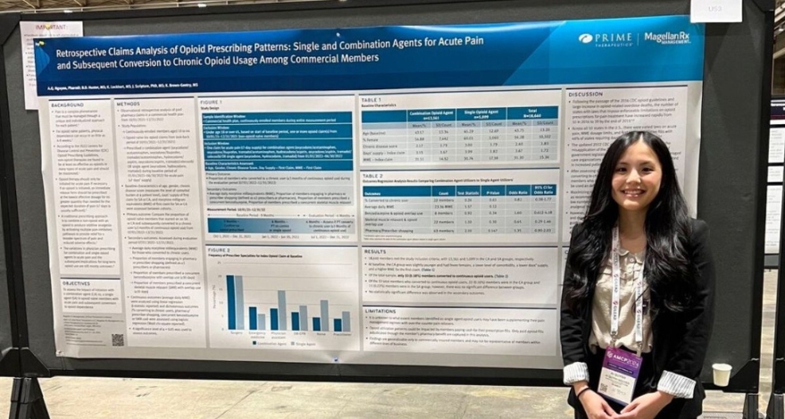 Ai Quynh Nguyen, PharmD, stands in front of her research poster at AMCP Annual.
