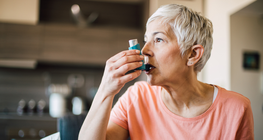 A woman uses an inhaler